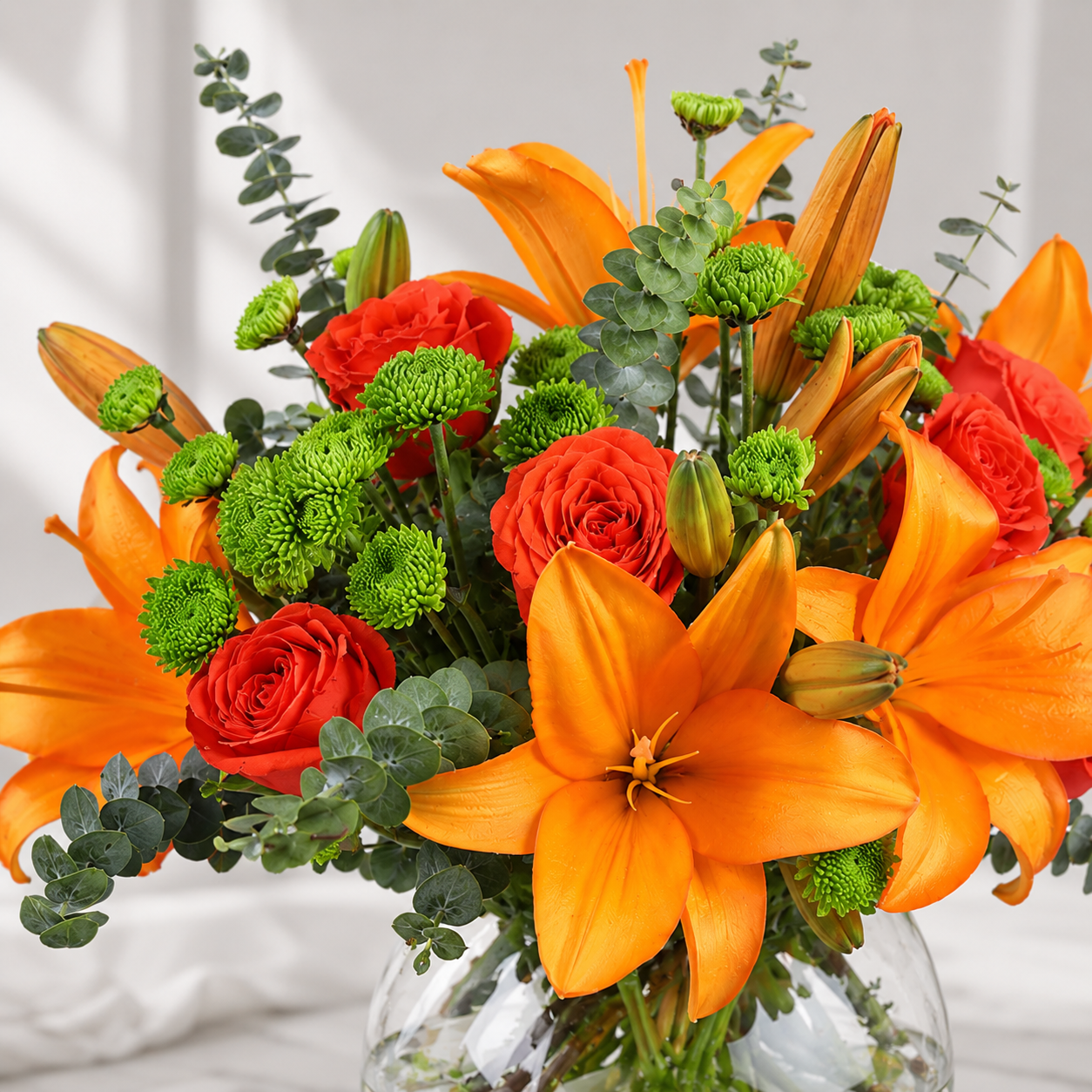 Orange Lilies and Roses Bouquet in Glass Vase