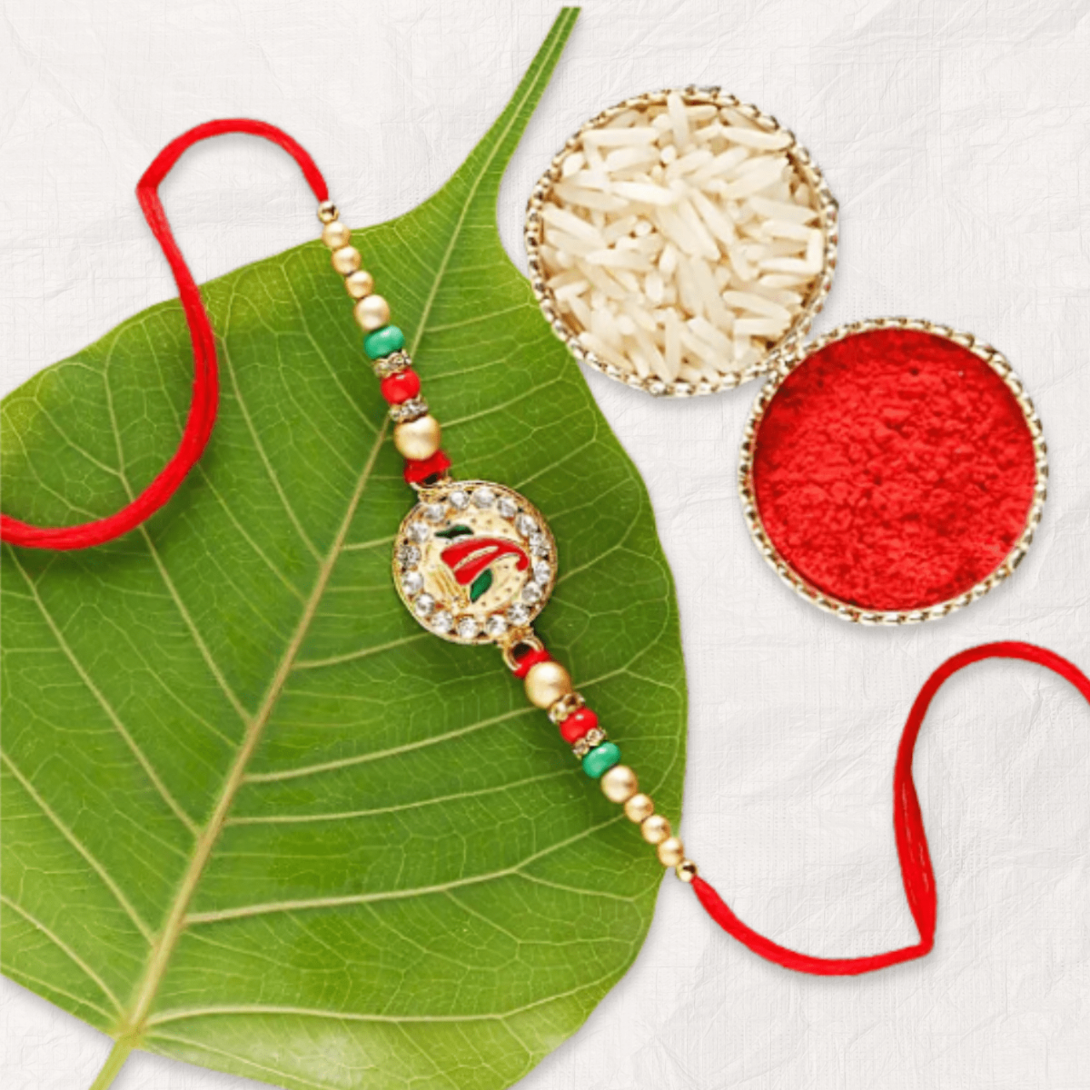 Elegant Ganesha Rakhi with Rice and Kumkum